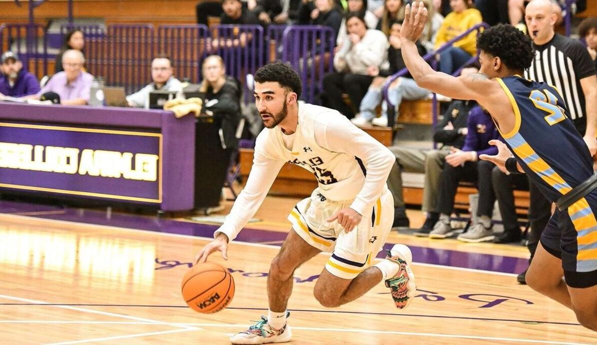 A male basketball player drives to the hoop during a game